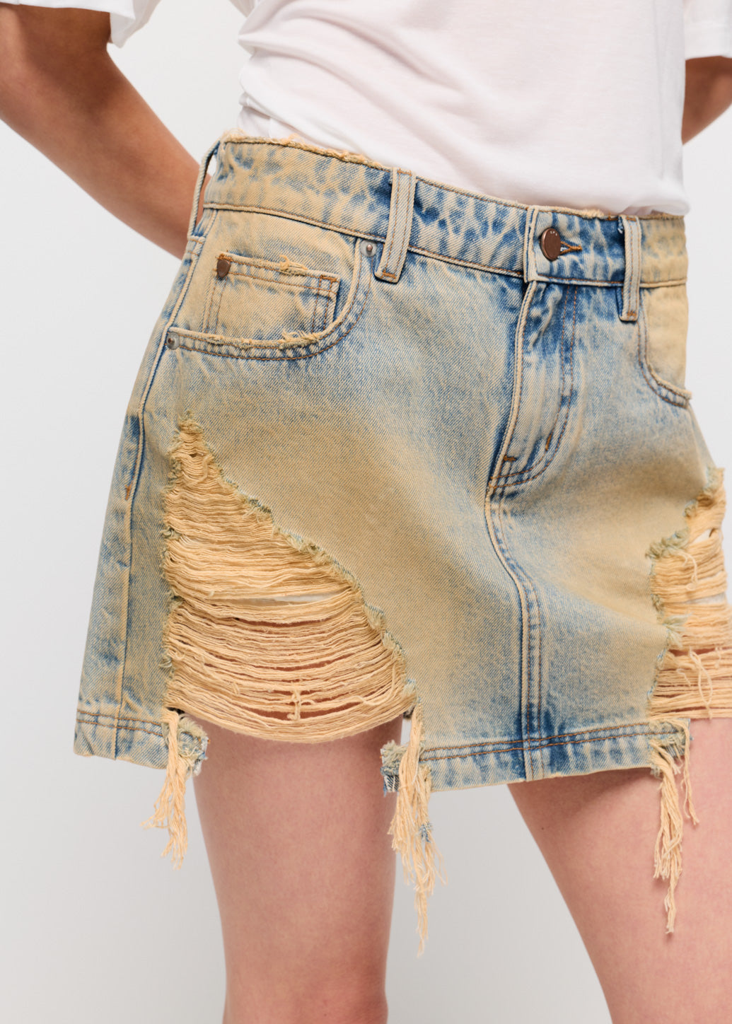 DISTRESSED DENIM MINI SKIRT